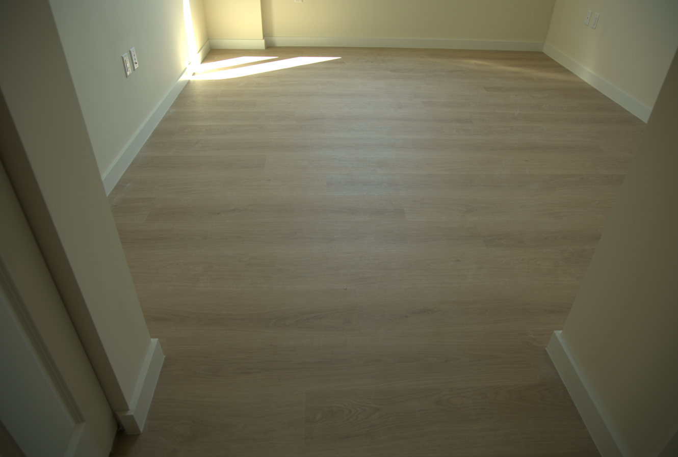 Large-format porcelain plank flooring in a new construction living room